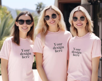 May include: Three women wearing pink t-shirts with the text "Your design here" printed on the front. They are all wearing sunglasses and smiling.