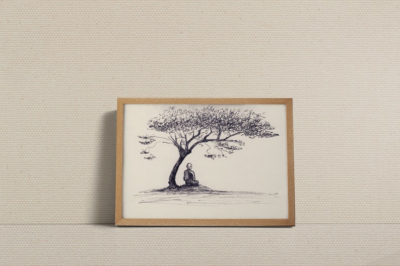May include: A framed pen and ink drawing depicts a person meditating under a tree. The artwork is in a natural wood frame and set against a neutral background. The drawing is detailed with fine lines, creating a serene and contemplative scene.