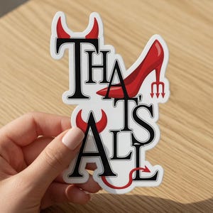 May include: A white sticker with the text "THAT'S ALL" in black, with red devil horns and a red high heel shoe. The sticker has a devilish theme.