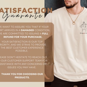 May include: Cream-colored t-shirt with a line drawing of a person holding a child, and the text "Daddy & Anything". The shirt also features a "Satisfaction Guarantee" message.