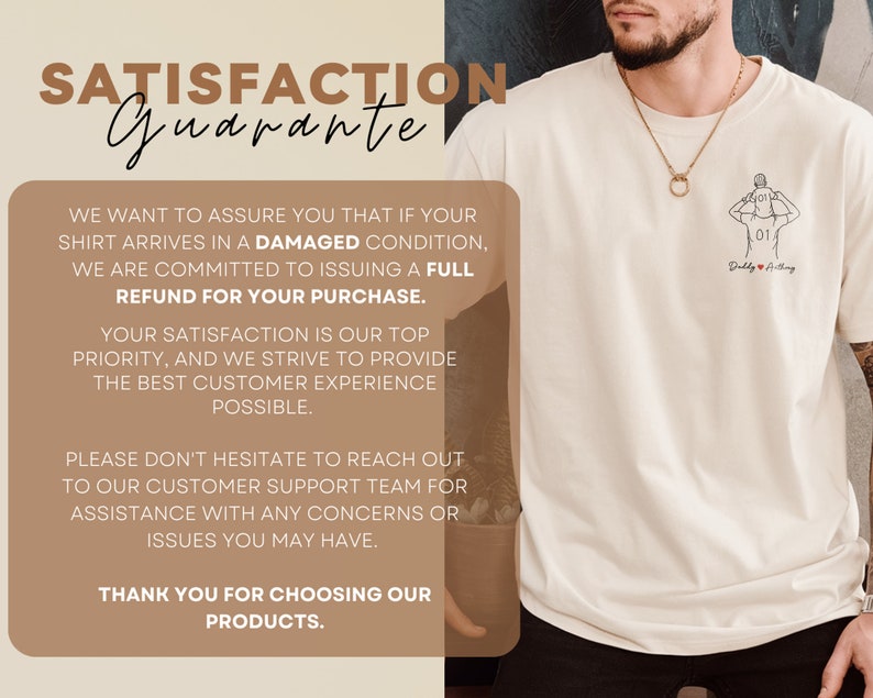May include: Cream-colored t-shirt with a line drawing of a person holding a child, and the text "Daddy & Anything". The shirt also features a "Satisfaction Guarantee" message.