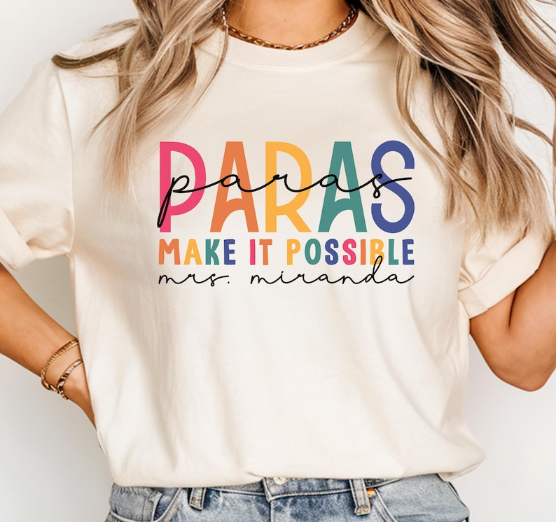 May include: A white t-shirt with the text "paras make it possible mrs. miranda" in rainbow colors.