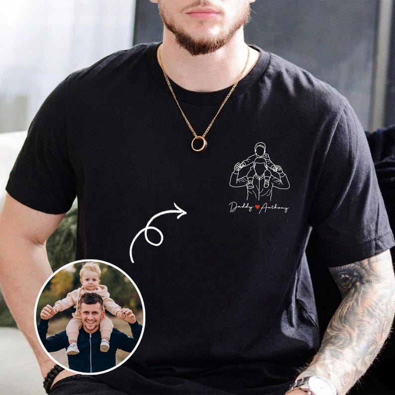 May include: Black t-shirt featuring a line drawing of a person carrying a child on their shoulders, with the text "Daddy ❤️ Anthony". A photo of a person carrying a child is in a circular inset.