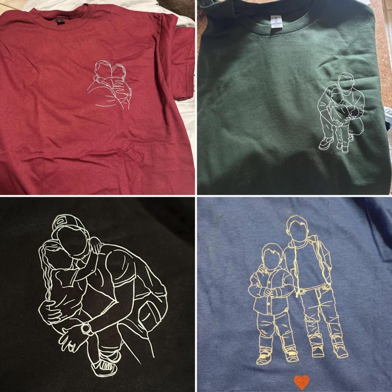 May include: Four t-shirts in various colors: burgundy, dark green, black, and blue. Each shirt features a white line drawing of a parent and child embracing. The blue shirt has a small red heart at the bottom.