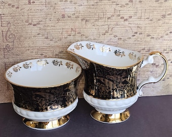 MCM Elizabethan Sovereign Black creamer and sugar bowl set featuring gold floral leaf on black background. Circa 1960's - early 1980's