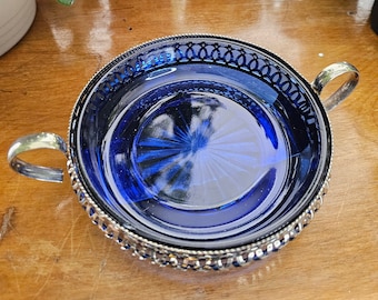 Collector's Candy dish bowl in cobalt blue glass with chrome metal base and handles. It is in Excellent condition.