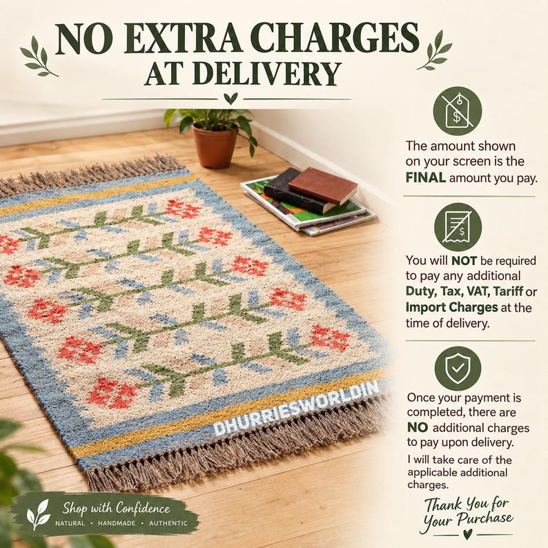 May include: A rectangular area rug with a cream-colored base featuring a repeating pattern of green stems and red flowers. The rug has blue and yellow borders and brown fringe on the ends. Text on the rug reads DHURRIESWORLDIN.