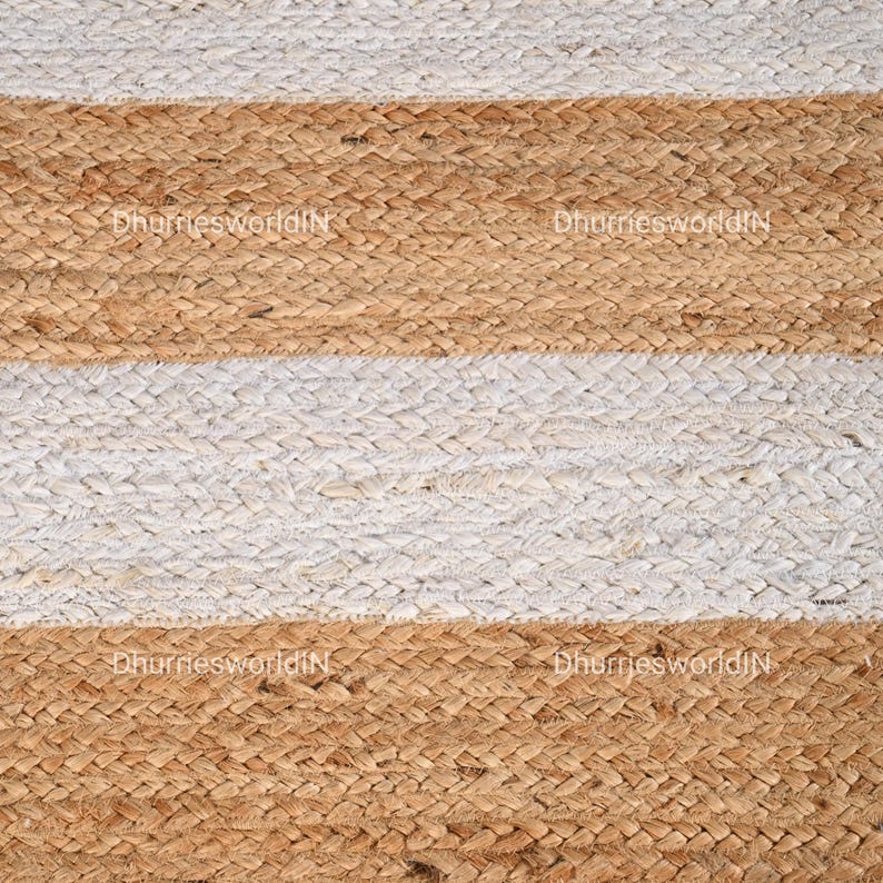 May include: A striped jute rug with alternating white and natural brown stripes. The rug is woven with a simple, textured pattern.