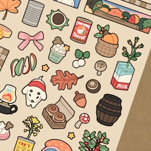 May include: A sheet of stickers with various illustrations, including a dog in a Santa hat, a coffee can, a milk carton, and a basket of pumpkins. The text "POKO'S YARD" is at the top.