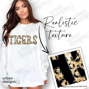 May include: White sweatshirt with the word "TIGERS" in gold glitter letters. The glitter letters have a leopard print pattern. The image shows a close-up of the glitter letters and a separate image of the leopard print pattern.