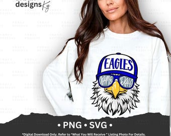 May include: A white sweatshirt with a blue and yellow eagle wearing sunglasses and a blue baseball cap that says "Eagles Game Day".