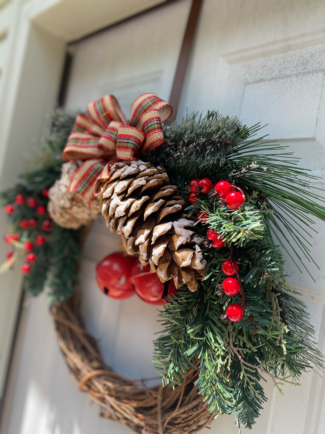 Festive Holiday Wreath With Pine Cones, Red Berries, and Jingle Bells ...