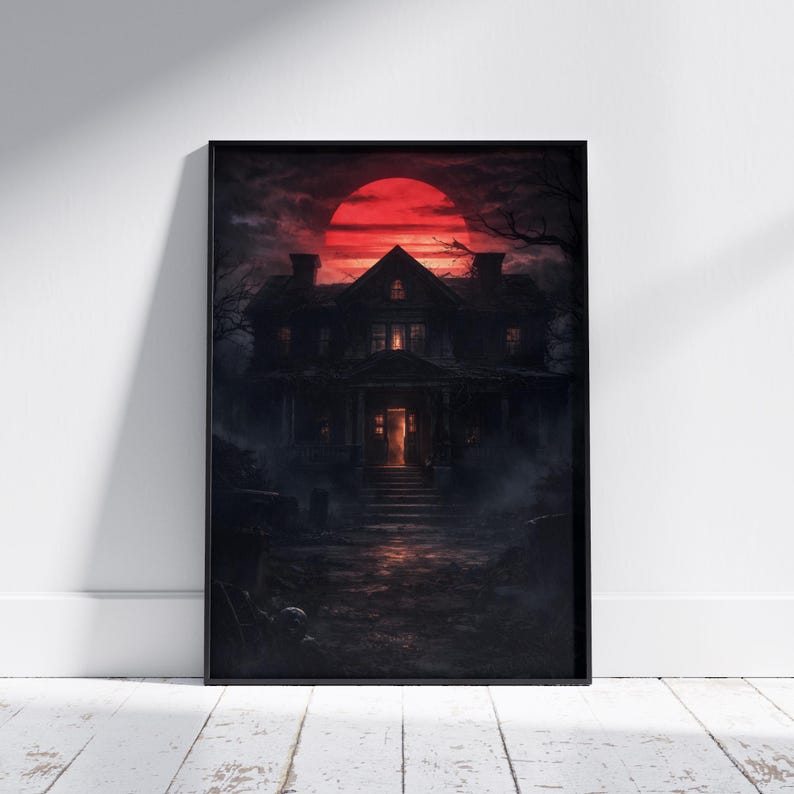Framed haunted mansion poster displayed in a moody interior setting, showing an eerie house under a deep red moon with glowing windows and overgrown surroundings. This gothic wall art creates a mysterious and immersive decor atmosphere.