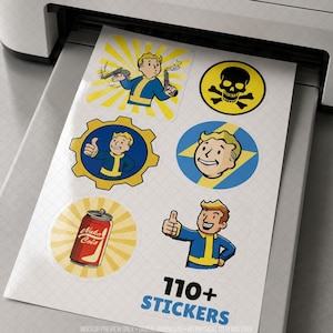 Printable sticker sheet shown freshly printed from a home printer, featuring retro-inspired cartoon character icons, vintage badges, a soft drink can, warning symbols and colorful gaming-themed graphics. Mockup highlights high-resolution digital download with over 110 printable stickers for laptops, journals, planners, water bottles, scrapbooking and gaming accessories, inspired by classic post-apocalyptic retro aesthetics without referencing copyrighted titles or characters.