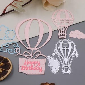 May include: A set of three ceramic mugs with a speckled, matte finish in cream, light grey, and dark grey. Each mug has a minimalist design, ideal for coffee or tea.