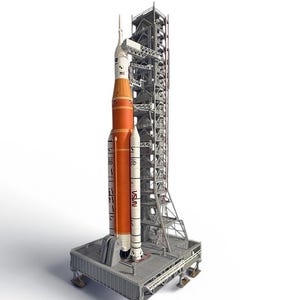 May include: A detailed model of a NASA rocket and launch tower. The rocket is primarily orange and white, with the NASA logo visible. The launch tower is a complex structure of gray metal. The model is set on a gray platform.