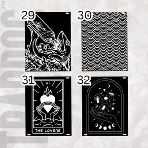 May include: Four black and white metal signs with unique designs. One features a shark with a bottle, another has a wave pattern, a third displays a tarot card, and the last shows mushrooms and stars.