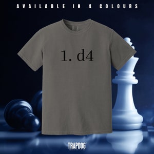 May include: A gray t-shirt with the text "1. d4" printed on the front. The shirt is on a chessboard background.