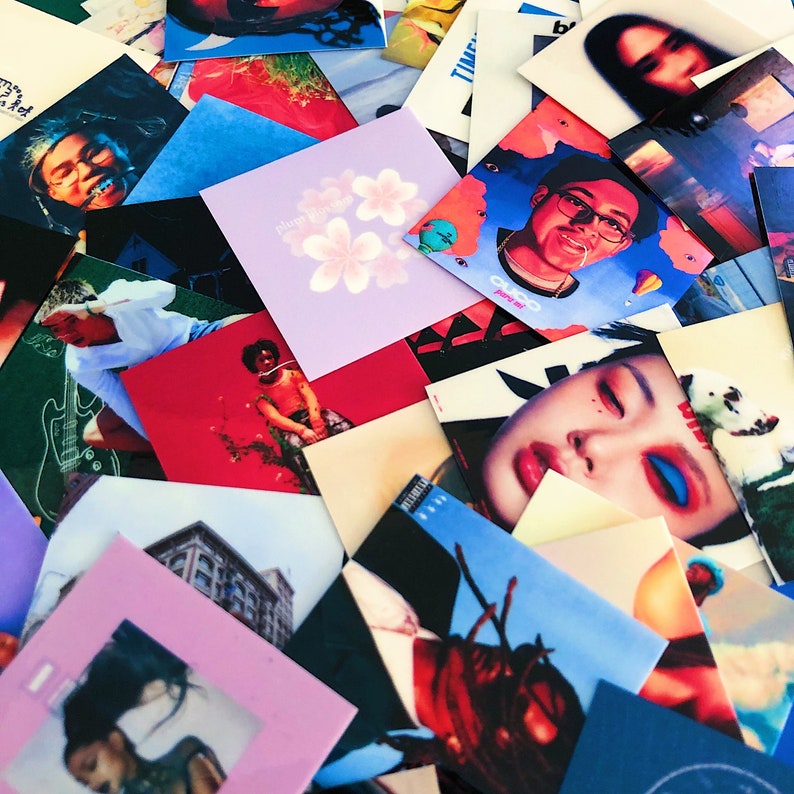 May include: A collection of square album art covers with various illustrations and portraits. The covers feature diverse colors, including purple with floral designs, portraits with blue and red tones, and images of buildings.