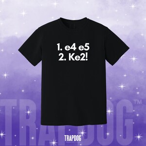 May include: Black t-shirt with white text that reads "1. e4 e5 2. Ke2!"