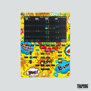 May include: A yellow and black patterned skin for a music production device. The skin features comic book style speech bubbles with words like "Bang!" and "Ouch!" The device has a screen that displays "Pattern 15" and "0:00 P15.911".