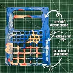 May include: A blue vinyl skin for the SP-404MKII sampler, featuring a Japanese-inspired floral design with a yellow bird. The skin has cutouts for all the buttons and knobs on the sampler. The text "your custom vinyl skin" is printed on the side of the skin.