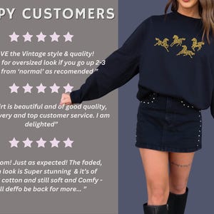 Customer review image showing happy customers wearing embroidered horse sweatshirts