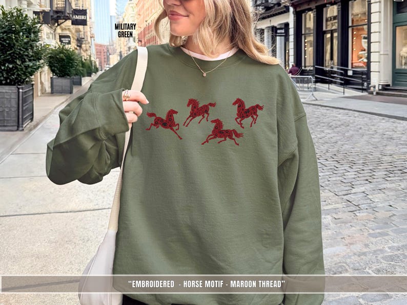 Woman wearing military green embroidered horse sweatshirt styled for everyday casual wear