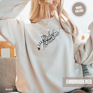 Grey Tabby Kitten Sweatshirt Embroidered Design Women Climbing Cat Pullover Top Large Chest Detail Quality Stitching Soft Cotton Blend Construction Cozy Comfortable Fit Animal Lover Apparel Perfect Gift Cat Mom Pet Parent Present Casual