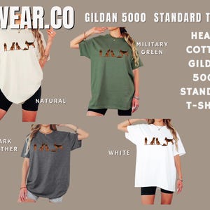 May include: Five different color t-shirts with a graphic print of a group of dogs. The colors are natural, military green, dark heather, white, and black. The text "WEAR.CO GILDAN 5000 STANDARD T-shirt" is at the top of the image. The text "HEAVY COTTON GILDAN 5000 STANDARD T-SHIRT" is on the right side of the image.