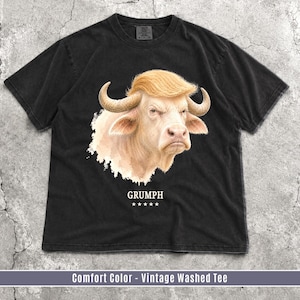 Black Comfort Colors GRUMPH buffalo graphic T-shirt flat lay with grumpy albino buffalo portrait.