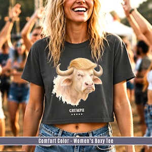 Women’s boxy crop tee in Pepper with funny GRUMPH albino buffalo graphic at summer festival.