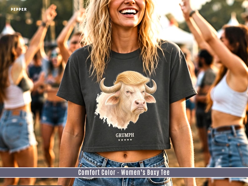 Women’s boxy crop tee in Pepper with funny GRUMPH albino buffalo graphic at summer festival.