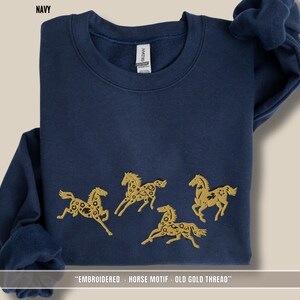 Navy blue unisex sweatshirt featuring old gold & black embroidered horses across the chest