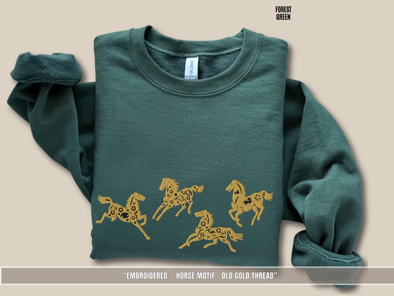 Flat lay of forest green sweatshirt showing detailed old gold & black horse embroidery stitching