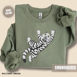 Embroidered Cat Sweatshirt Women Grey Tabby Kitten Design Climbing Feline Pullover Top Perfect Cat Mom Gift Idea Pet Parent Present Birthday Occasion Animal Lover Apparel Cozy Cotton Blend Soft Comfortable Construction Large Chest Detail
