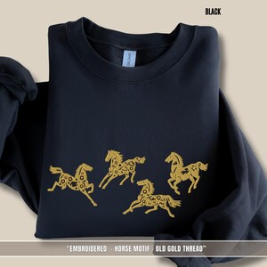Black unisex sweatshirt with old gold embroidered horses inspired by equestrian and Scandinavian folklore style