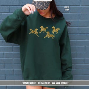 Forest green sweatshirt with old gold & black embroidered horse design inspired by equestrian riding culture
