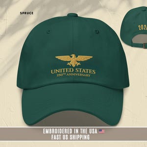 Light blue embroidered United States 250th anniversary baseball cap with eagle emblem, worn outdoors in natural light.