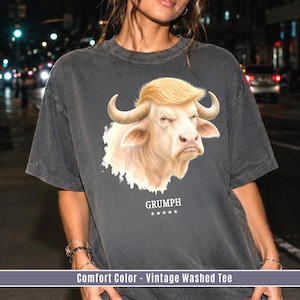GRUMPH funny albino buffalo graphic shirt on Pepper Comfort Colors tee with grumpy bull portrait and festival streetwear style.