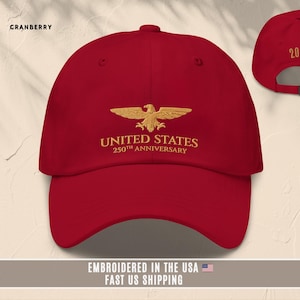 Red embroidered United States 250th anniversary baseball cap with eagle logo, front and back shown.