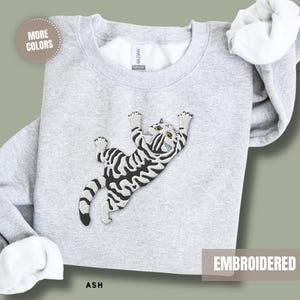 Animal Lover Sweatshirt Women Embroidered Cat Design Grey Tabby Kitten Climbing Feline Pullover Top Pet Parent Apparel Cat Mom Gift Idea Cozy Cotton Blend Soft Comfortable Construction Large Chest Detail Birthday Present Cat Lady Essential