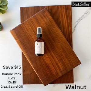 May include: Two rectangular walnut wood cutting boards with a smooth finish, layered one over the other. A small amber glass spray bottle labeled Board Oil sits on the top board. The text on the image includes Best Seller, Save $15, Bundle Pack, 8x12, 10x15, 2 oz. Board Oil, and Walnut.