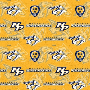 May include: A repeating pattern featuring the Nashville Predators logo and wordmark. The design includes the team's saber-tooth tiger logo in white and navy blue, along with the team name. The background is a textured gold color.