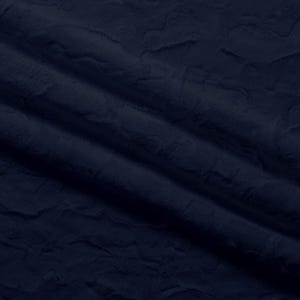 May include: A close-up shot of a navy blue fabric with a textured, wrinkled surface. The fabric has a soft, plush appearance, with visible folds and shadows that create depth and dimension. The dark blue color is consistent throughout the material.