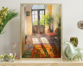 May include: A painting of a sunlit room with a large wooden door, a potted plant, a chair, and a colorful rug. The painting is framed in a gold frame and has the text "SAGUARO PRINTS CO." at the bottom.