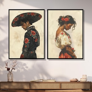 May include: Two framed paintings depicting a man and a woman in traditional Mexican attire. The man is wearing a black suit with red roses embroidered on it and a wide-brimmed hat. The woman is wearing a white blouse with red embroidery and a red skirt.