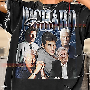May include: Black t-shirt featuring a collage of actors with the text "RICHARD Gere" in a stylized font. The design includes images of the actors with a blue and white lightning bolt background.