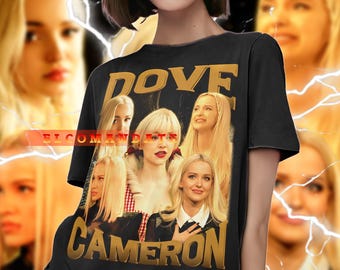 May include: Black t-shirt featuring a collage of images and the text "DOVE CAMERON" in gold. The shirt has a vintage style with a faded background. The model is wearing blue jeans.
