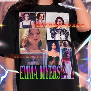 May include: Black t-shirt with a collage of images and the text "ELCOMANDATE" and "EMMA MYERS" in green. The shirt is worn by a person. The shirt is a unisex style.